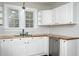 Well-lit kitchen featuring white cabinets, butcher block countertops, and stainless steel appliances at 601 Rose St, Rocky Mount, NC 27801
