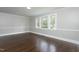 Bright living room featuring hardwood floors and large windows with natural light at 601 Rose St, Rocky Mount, NC 27801