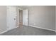 Simple bedroom with grey carpet and neutral walls at 609 E Cockrell St, Nashville, NC 27856