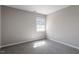 Spacious bedroom with a window and grey carpeting at 609 E Cockrell St, Nashville, NC 27856