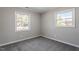 Well-lit bedroom featuring grey carpeting and neutral walls at 609 E Cockrell St, Nashville, NC 27856