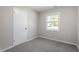 Cozy bedroom with grey carpet and a window at 609 E Cockrell St, Nashville, NC 27856
