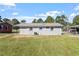 Gray brick house exterior with a large backyard at 609 E Cockrell St, Nashville, NC 27856