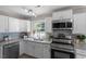 Modern kitchen with white cabinets, granite counters, and stainless steel appliances at 609 E Cockrell St, Nashville, NC 27856