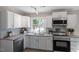 Modern kitchen with white cabinets, granite counters, and stainless steel appliances at 609 E Cockrell St, Nashville, NC 27856