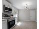 Modern kitchen with white cabinets, granite countertops, and stainless steel appliances at 609 E Cockrell St, Nashville, NC 27856