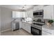 Modern kitchen with white cabinets, granite counters, and stainless steel appliances at 609 E Cockrell St, Nashville, NC 27856