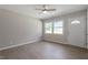 Bright living room with neutral walls, wood-look floors, and a ceiling fan at 609 E Cockrell St, Nashville, NC 27856