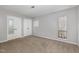 A bedroom with neutral carpet and paint, featuring a window and closet at 635 Pine Ridge Pl, Raleigh, NC 27609