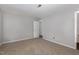 A neutral bedroom with carpet and a visible doorway to an adjoining room at 635 Pine Ridge Pl, Raleigh, NC 27609