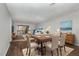 Open dining area with wood flooring, a modern table set, and deck access at 635 Pine Ridge Pl, Raleigh, NC 27609