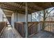 Apartment entrance with wooden porch, stairs, and metal supports above at 635 Pine Ridge Pl, Raleigh, NC 27609