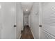 Inviting hallway featuring wood-look flooring and neutral paint, creating a seamless flow throughout the home at 635 Pine Ridge Pl, Raleigh, NC 27609