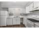 Well-lit kitchen with white cabinets and a full suite of appliances at 635 Pine Ridge Pl, Raleigh, NC 27609