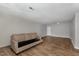 Open living room with modern hard surface flooring and ample space for relaxation at 635 Pine Ridge Pl, Raleigh, NC 27609