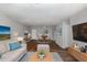 Inviting living room with contemporary furniture, wood floors, and access to dining and entertainment at 635 Pine Ridge Pl, Raleigh, NC 27609