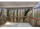 Outside porch looking out to a lush, wooded landscape and mature trees at 635 Pine Ridge Pl, Raleigh, NC 27609