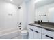 Modern bathroom with white subway tile and dark vanity at 705 Colleton Rd, Raleigh, NC 27610