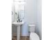 Simple, clean powder room with pedestal sink and toilet at 705 Colleton Rd, Raleigh, NC 27610