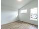 Bright bedroom with light wood flooring and multiple windows at 705 Colleton Rd, Raleigh, NC 27610