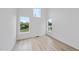 Bright bedroom with light wood flooring and multiple windows at 705 Colleton Rd, Raleigh, NC 27610