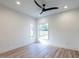 Bright bedroom with hardwood floors and ceiling fan at 705 Colleton Rd, Raleigh, NC 27610