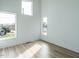 Bright bedroom with light wood flooring and multiple windows at 705 Colleton Rd, Raleigh, NC 27610