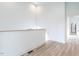 Hallway with light wood flooring and access to bathroom at 705 Colleton Rd, Raleigh, NC 27610