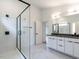 Modern bathroom with double vanity, large shower, and marble floors at 707 Colleton Rd, Raleigh, NC 27610