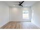 Bright bedroom with hardwood floors and two windows at 707 Colleton Rd, Raleigh, NC 27610