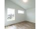 Bright bedroom with wood floors and large windows at 707 Colleton Rd, Raleigh, NC 27610