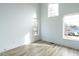 Bright bedroom with wood floors and large windows at 707 Colleton Rd, Raleigh, NC 27610