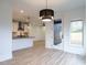 Bright dining room with hardwood floors and view of kitchen at 707 Colleton Rd, Raleigh, NC 27610