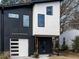 Modern two-story home with black and white exterior, attached garage, and landscaping at 707 Colleton Rd, Raleigh, NC 27610