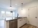 Modern kitchen with stainless steel appliances and a large island at 707 Colleton Rd, Raleigh, NC 27610