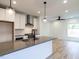 Modern kitchen with gray countertops, white cabinets, and stainless steel appliances at 707 Colleton Rd, Raleigh, NC 27610