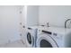 Laundry room with Whirlpool washer and dryer, and white tile flooring at 707 Colleton Rd, Raleigh, NC 27610