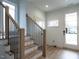 Modern staircase with light wood treads and black metal balusters at 707 Colleton Rd, Raleigh, NC 27610