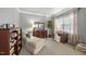 Relaxing bedroom with a chaise lounge, desk, and built-in shelving at 7112 Hasentree Way, Wake Forest, NC 27587
