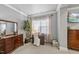 Functional bedroom with a desk, dresser, and large window at 7112 Hasentree Way, Wake Forest, NC 27587