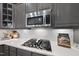 Stainless steel cooktop with gas burners and white quartz countertops at 7112 Hasentree Way, Wake Forest, NC 27587
