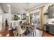 Bright dining area with round table and chairs, adjacent to kitchen at 7112 Hasentree Way, Wake Forest, NC 27587