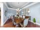 Formal dining room with a spacious table, hardwood floors, and decorative accents at 7112 Hasentree Way, Wake Forest, NC 27587
