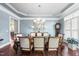 Elegant dining room featuring a large wood table, chandelier, and hardwood floors at 7112 Hasentree Way, Wake Forest, NC 27587