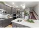 Open concept kitchen with stainless steel appliances and island seating at 7112 Hasentree Way, Wake Forest, NC 27587