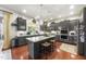 Modern kitchen featuring an island, stainless steel appliances, and hardwood floors at 7112 Hasentree Way, Wake Forest, NC 27587