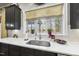 Modern kitchen sink with white quartz countertops and a farmhouse style faucet at 7112 Hasentree Way, Wake Forest, NC 27587