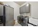 Bright laundry room with washer, dryer, sink, and ample cabinets at 7112 Hasentree Way, Wake Forest, NC 27587