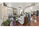 Open living room with hardwood floors, stone fireplace and access to kitchen at 7112 Hasentree Way, Wake Forest, NC 27587