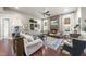 Cozy living room with stone fireplace, hardwood floors, and large windows at 7112 Hasentree Way, Wake Forest, NC 27587